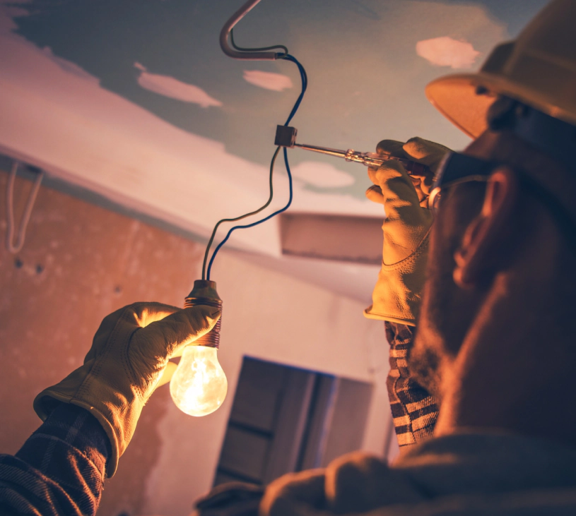 electrician installing a light bulb
